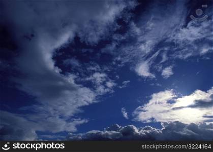 Sunlight Filtered Through Thin Clouds In A Dark Blue Sky