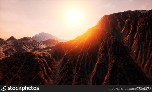 Sunlight rays over mountains in a valley. Sun Rays over Mountains in a Valley