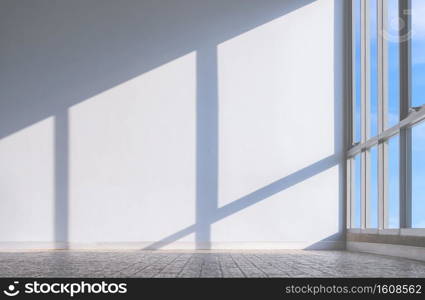 Sunlight shine through glass wall with shadow on white cement wall surface in modern living room, interior architecture background design