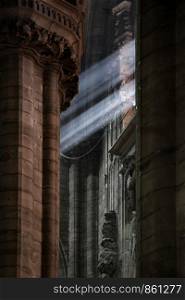 Sunlight shines with a beam of light in the dark cathedral