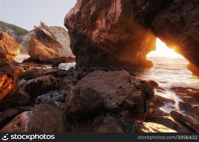 Sunlight through rock arch, Ursa beach, Portugal