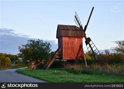 Sunlit old red wooden windmill at the swedish island Oland
