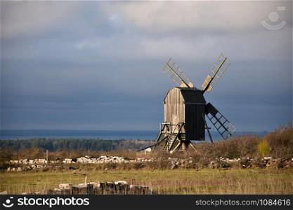 Sunlit old wooden windmill by fall season at the island Oland in Sweden
