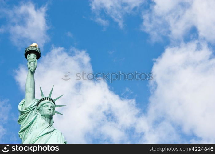 Sunnny day, blue sky with clouds: statue of Liberty with copy space