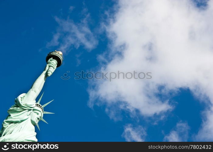 Sunnny day, blue sky with clouds: statue of Liberty with copy space