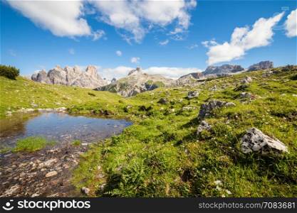 Sunny alpine mountain valley. Dolomites Alps, Italy