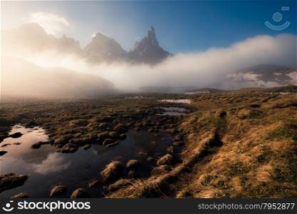 Sunny and foggy morning at the lake, Passo Rolle, Dolomites Alps, Italy