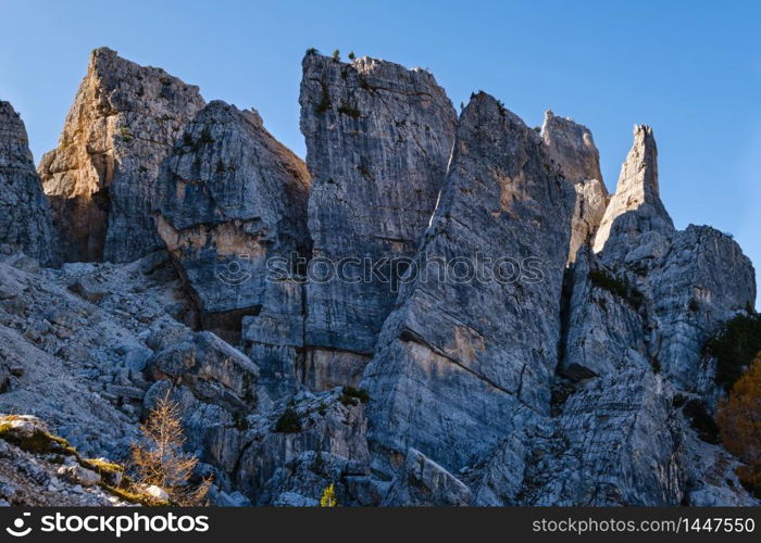 Sunny autumn alpine Dolomites rocky mountain scene, Sudtirol, Italy. Cinque Torri (Five pillars or towers) rock famous formation. Picturesque traveling, seasonal, hiking, nature beauty concept scene.