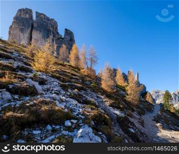 Sunny autumn alpine Dolomites rocky mountain scene, Sudtirol, Italy. Cinque Torri (Five pillars or towers) rock famous formation. Picturesque traveling, seasonal, hiking, nature beauty concept scene.