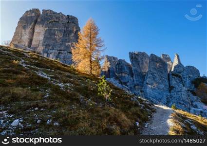 Sunny autumn alpine Dolomites rocky mountain scene, Sudtirol, Italy. Cinque Torri (Five pillars or towers) rock famous formation. Picturesque traveling, seasonal, hiking, nature beauty concept scene.