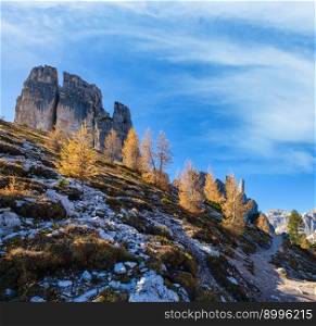 Sunny autumn alpine Dolomites rocky  mountain scene, Sudtirol, Italy. Cinque Torri (Five pillars or towers) rock famous formation. Picturesque traveling, seasonal, hiking, nature beauty concept scene.