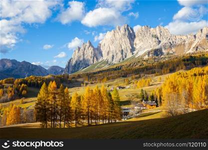 Sunny autumn day in Alpine mountains. Yellow larches in backlight. Sunny autumn day in mountains. Yellow larches in backlight