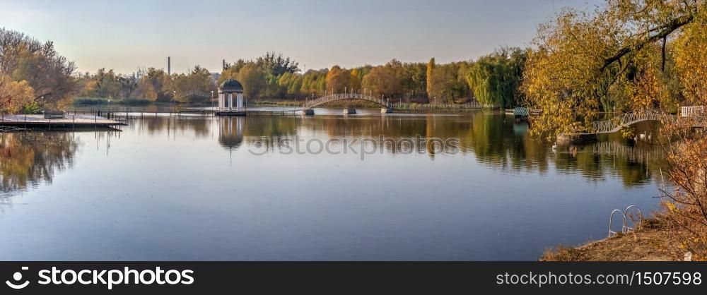 Sunny autumn evening on the blue lake with yellow trees. The Ivanki village in Cherkasy region, Ukraine. Sunny autumn evening on the blue lake