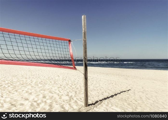 Sunny beach recreation day with a volleyball net on white sand at North Sea, on Sylt island, Germany. Summer vacation destination in Northern Europe.