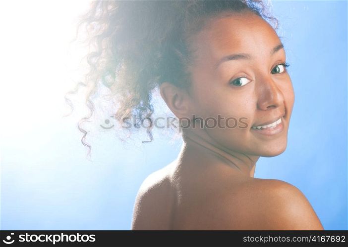 sunny beautiful mulatto laughing woman on sky background
