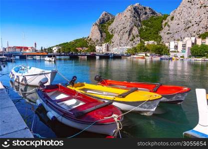 Sunny beautiful view of Cetina river, mountains and Old town in Omis, very popular tourist spot in Croatia. Sunny town and port Omis, Croatia