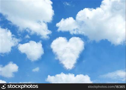 Sunny blue sky with a cloud in the shape of a heart