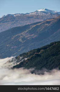 Sunny idyllic autumn alpine scene. Peaceful misty morning Alpsview from hiking path from Dorfgastein to Paarseen lakes, Land Salzburg, Austria. Picturesque hiking and seasonal concept scene.