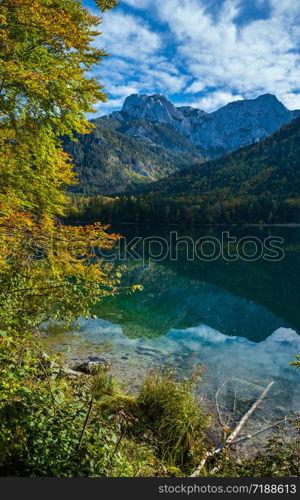 Sunny idyllic colorful autumn alpine view. Peaceful mountain lake with clear transparent water and reflections. Langbathseen lake, Upper Austria.