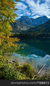 Sunny idyllic colorful autumn alpine view. Peaceful mountain lake with clear transparent water and reflections. Langbathseen lake, Upper Austria.