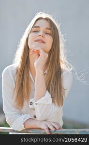 Sunny light portrait of a beauty with long hair.. A young beauty on a sunny spring day 2964.