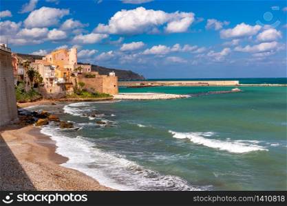 Sunny medieval fortress in Cala Marina, harbor in coastal city Castellammare del Golfo and Cala Petrolo Beach, Sicily, Italy. Castellammare del Golfo, Sicily, Italy