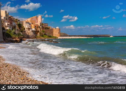 Sunny medieval fortress in Cala Marina, harbor in coastal city Castellammare del Golfo and Cala Petrolo Beach, Sicily, Italy. Castellammare del Golfo, Sicily, Italy