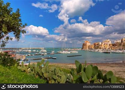 Sunny medieval fortress in Cala Marina, harbor in coastal city Castellammare del Golfo, Sicily, Italy. Castellammare del Golfo, Sicily, Italy