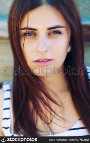 Sunny portrait of a beautiful young girl closeup.