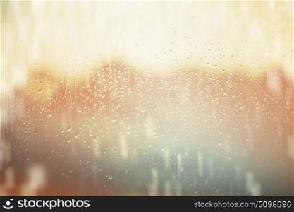 Sunny rain water drops on window glass background.