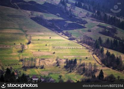 Sunny spring in mountain village. Fields and hills. April in Ukraine Carpathians