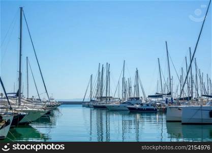 Sunny summer day. Blue sky and lot of sailing yachts in a marina. Plenty of Sailing Yachts in the Boat Parking Lot on a Sunny Summer Day
