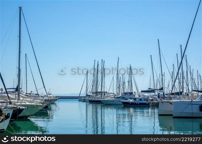 Sunny summer day. Blue sky and lot of sailing yachts in a marina. Plenty of Sailing Yachts in the Boat Parking Lot on a Sunny Summer Day