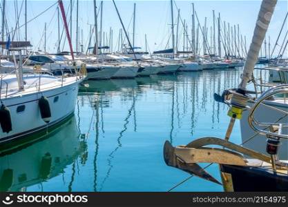 Sunny summer day. Small greek town. Lots of sailing yachts in a marina. Mediterranean City in Sunny Weather and Yacht Mooring