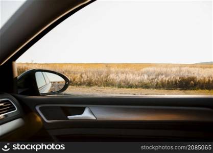 sunny view field from elegant car