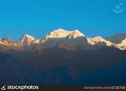 Sunrise above Kangchenjunga, India. Snow big mountains with blue sky.
