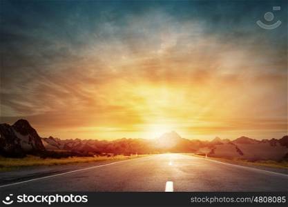 Sunrise above road. Empty asphalt road and sun rising at skyline