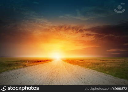 Sunrise above road. Empty asphalt road and sun rising at skyline