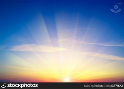 Sunrise against blue sky and white clouds