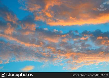 sunrise and red clouds on blue sky