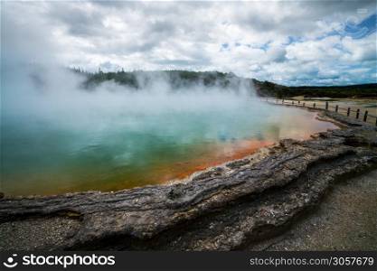 Sunrise at Champagne Pool in Wai-O-Tapu thermal wonderland in Rotorua, New Zealand. Rotorua is known for geothermal activity, geysers and hot mud pool located around the Lakes of Rotorua.