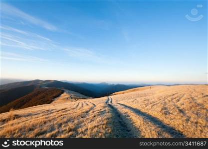Sunrise Carpathian Mountains (Ukraine) autumn landscape with country road.