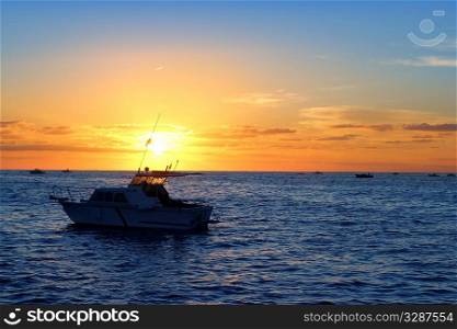 Sunrise fishing boat blue sea orange sky in Mediterranean