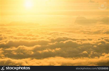 Sunrise foggy mist covered mountain forest landscape top view yellow sky background