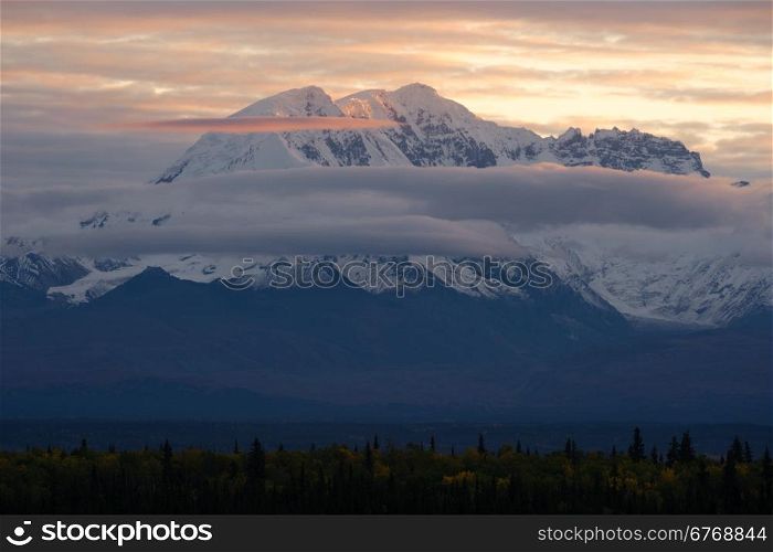 Sunrise happens behind Mt. Drum in remote Alaska