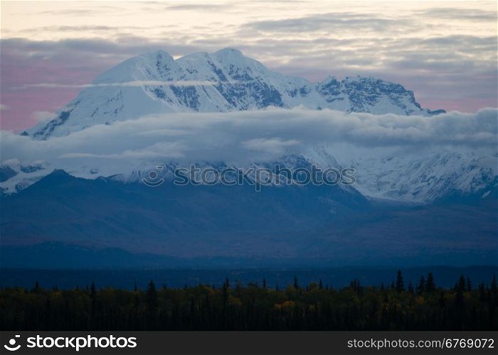 Sunrise happens behind Mt. Drum in remote Alaska