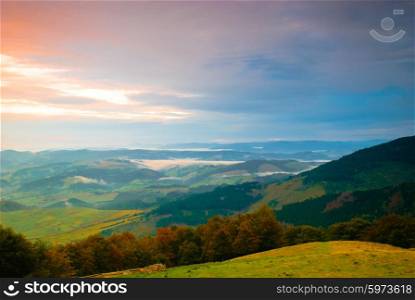 Sunrise in misty morning and village view from Carpathian mountains. Sunrise in misty morning