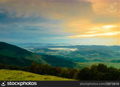 Sunrise in misty morning and village view from Carpathian mountains. Sunrise in misty morning
