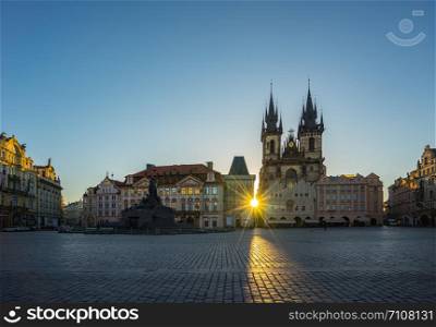 Sunrise in Prague old town square with view of Tyn Church in Czech Republic.