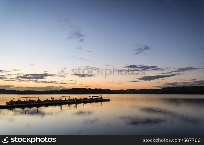 Sunrise landscape of jetty on calm lake